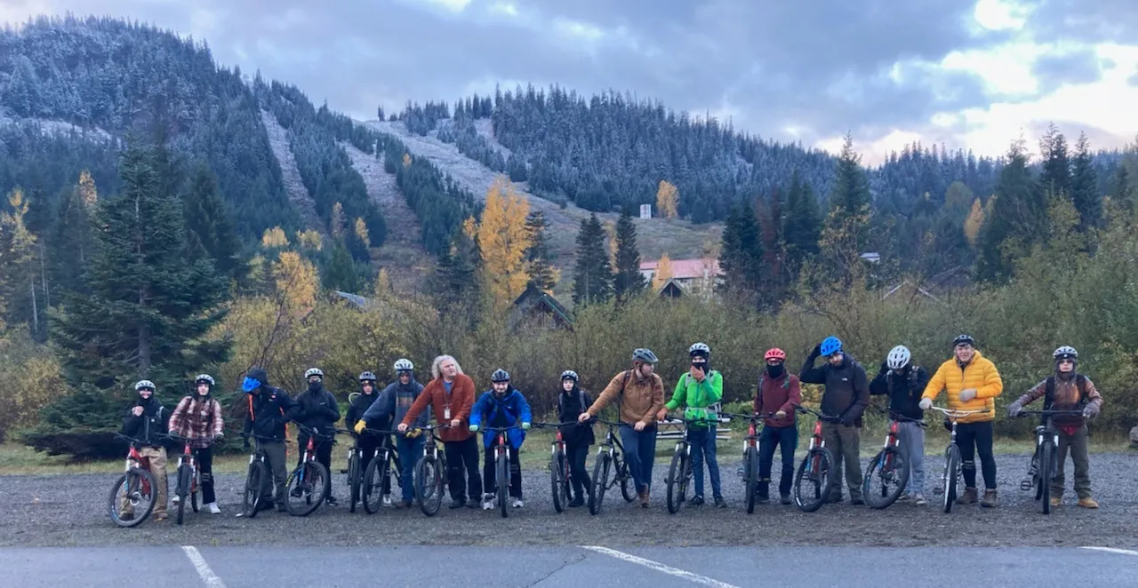 A group lined up with bicycles before a ride